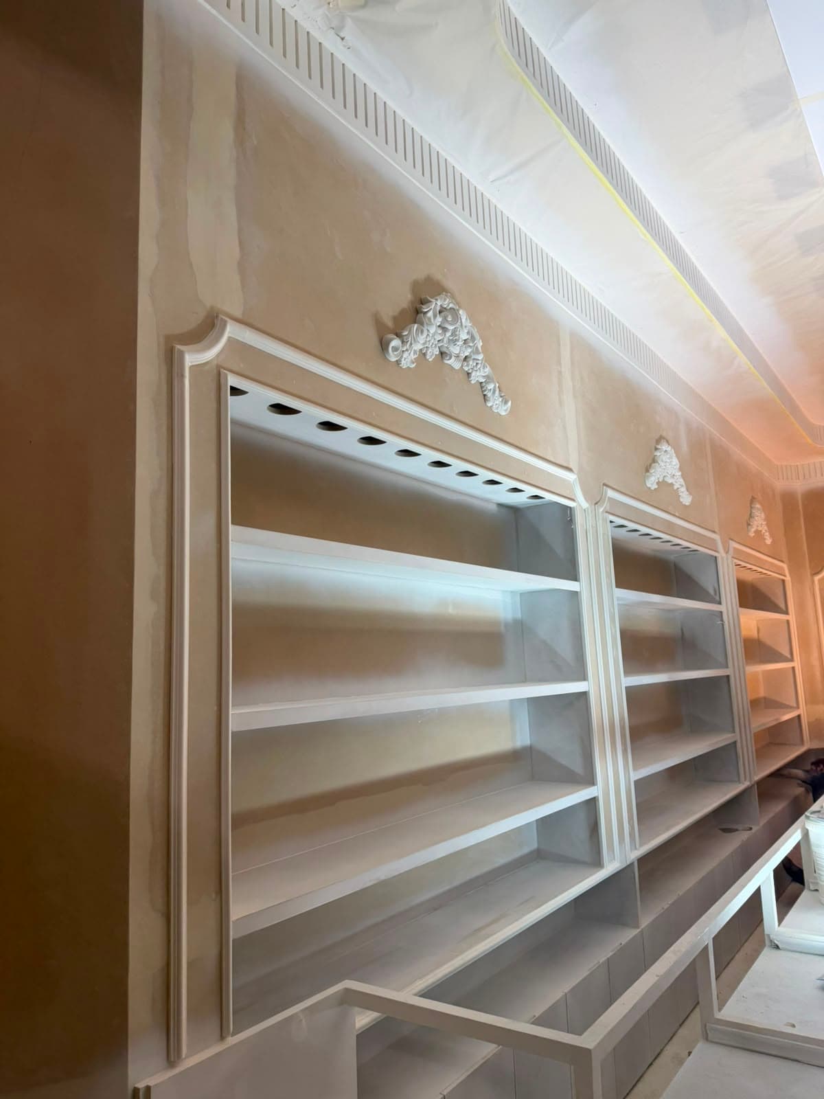 Retail shelving under construction with mouldings being fitted